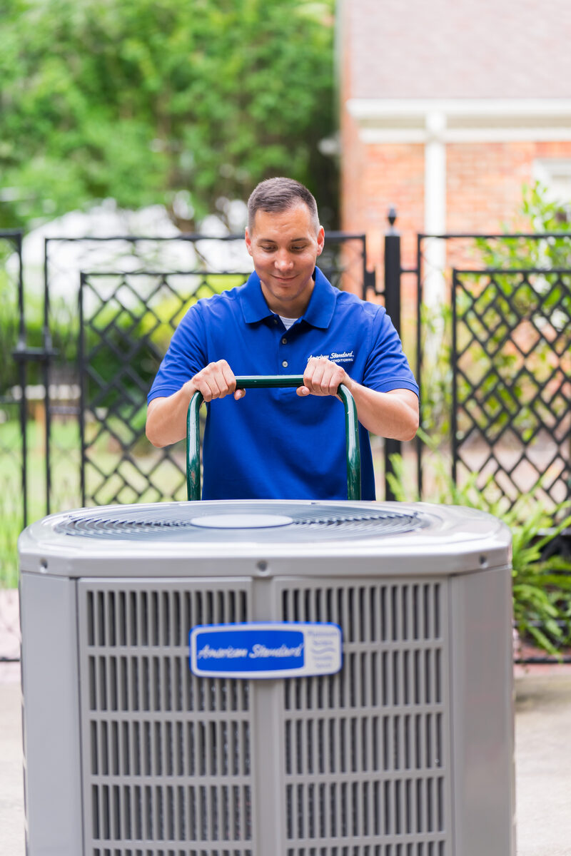 Service technician working on a residential heat pump system